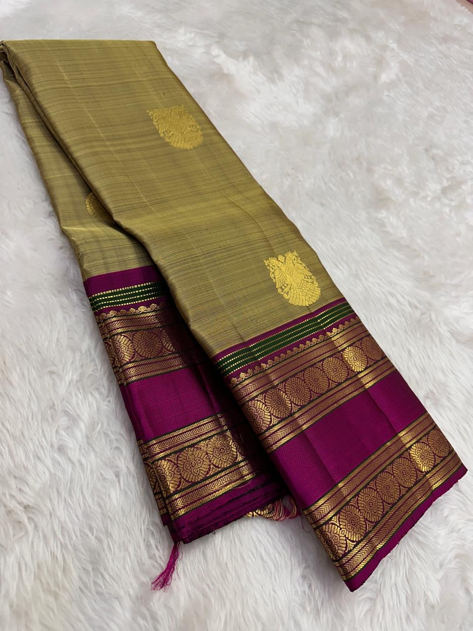 Champagne gold handwoven Pure Silk Kanjivaram saree with magenta border, full drape view.