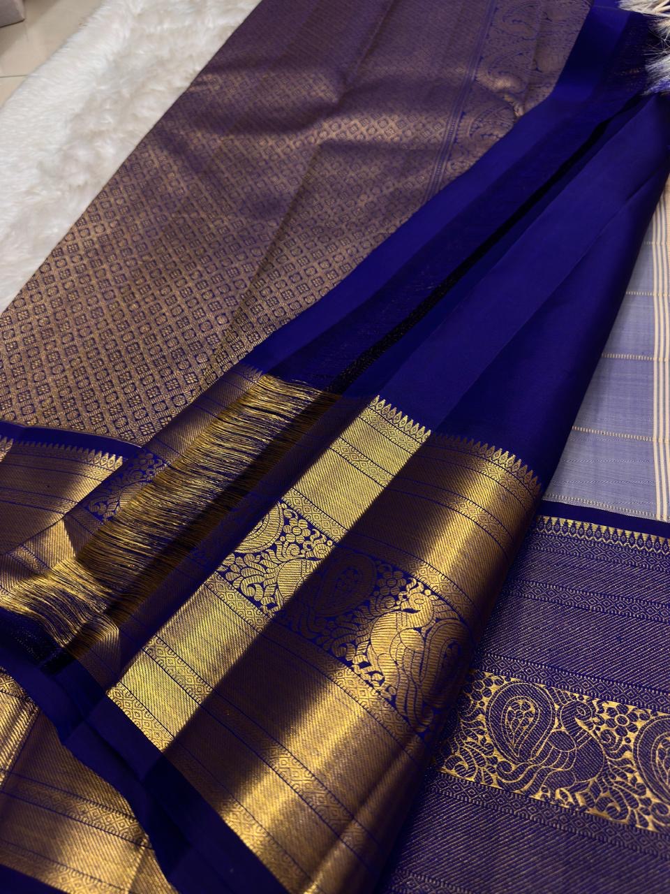 Warm sandalwood-ivory Kanchipuram silk body showing a fine classic-gold zari kattam and traditional buttas.