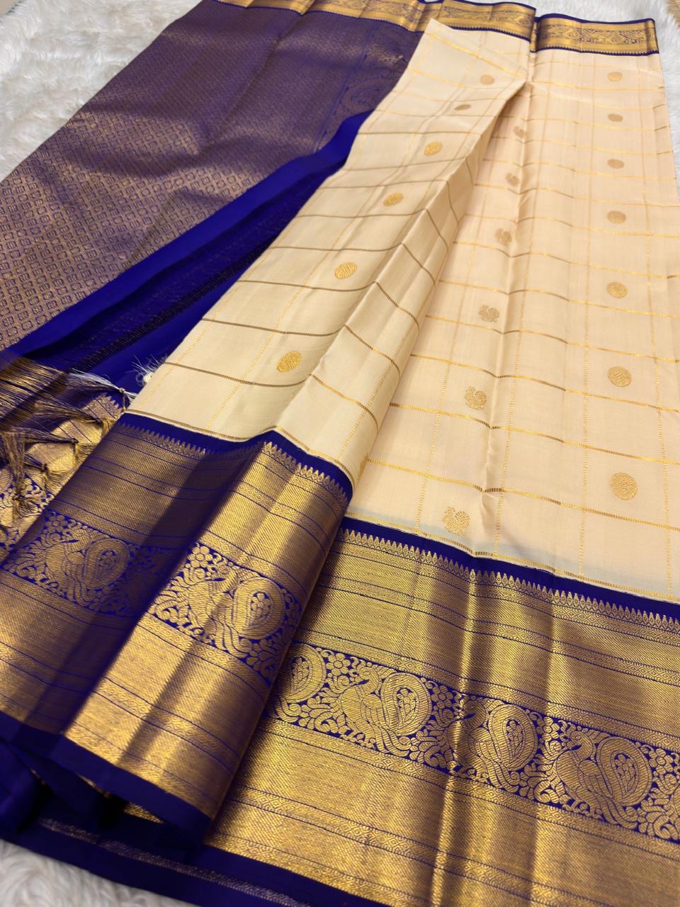 Chandanam Ivory pure silk Kanchipuram Zari Kattam saree with deep Karu Neelam Mayil gold zari border.