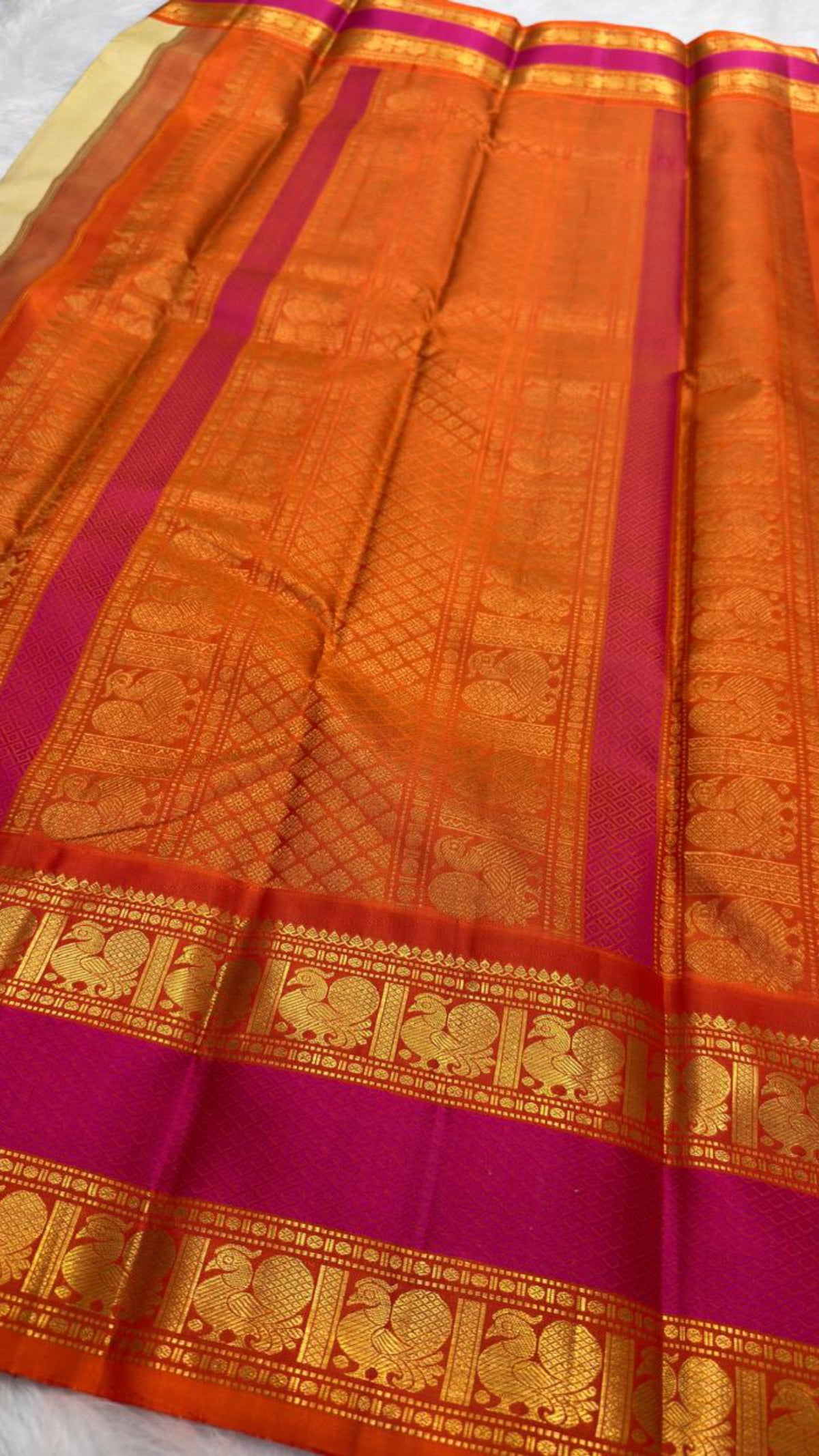 Pure silk Chandanam saree displaying the calm ivory body against its high-visual orange border.