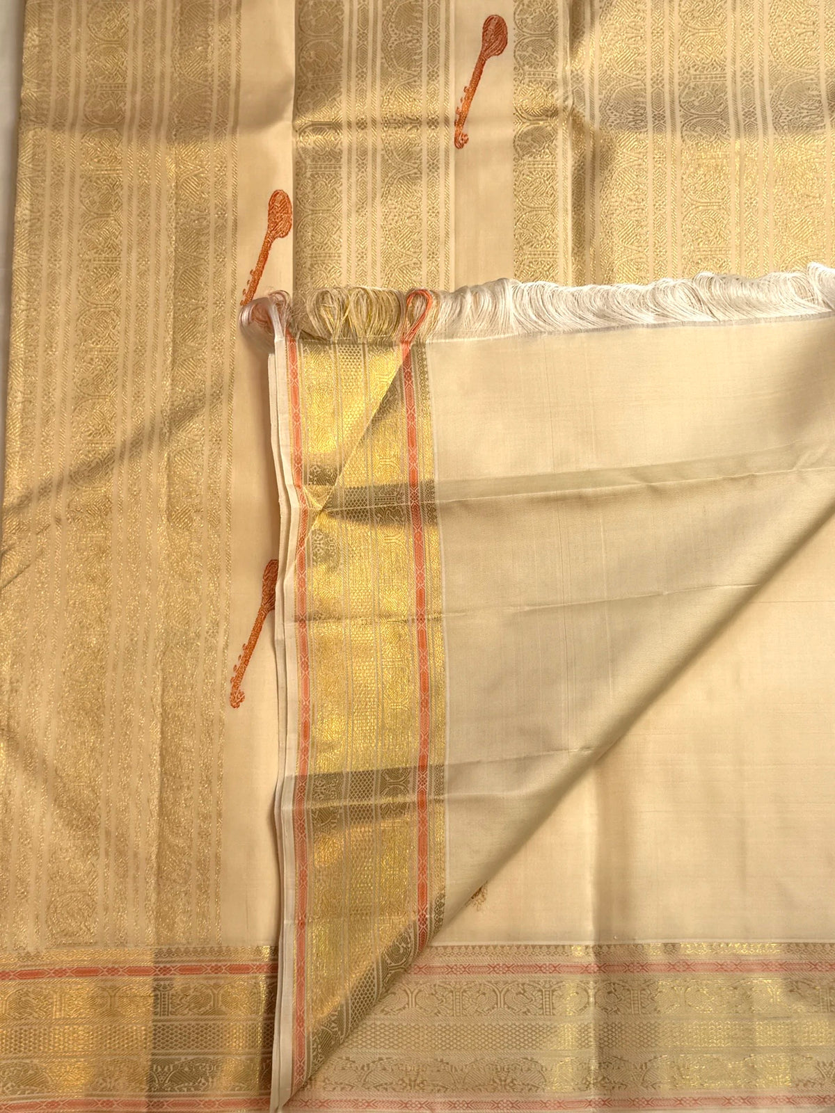 Close detail of the Sorgavaasal border with peacock motifs in silk thread and zari.