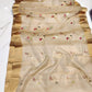 Champagne beige Chanderi Pattu silk saree showing its sheer golden body with floral buttas and wide gold border