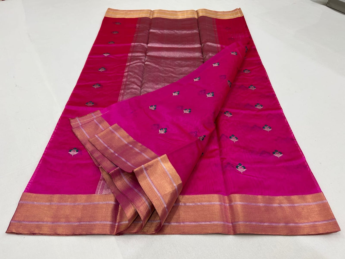 Rani pink Chanderi saree laid open showing the broad gold border with lavender-pink stripes and metallic pallu