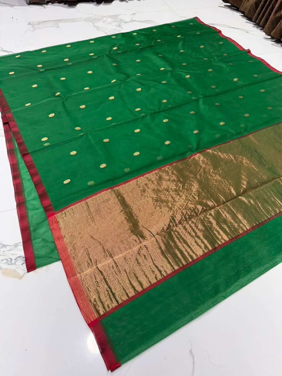 Gold zari border with pink-red edge on fresh green Chanderi saree