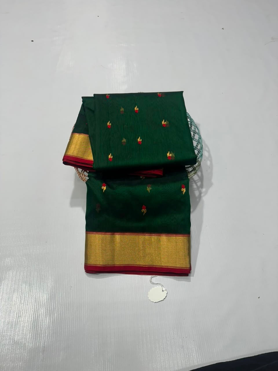 Emerald green Chanderi Pattu silk saree, red and gold floral butta detail