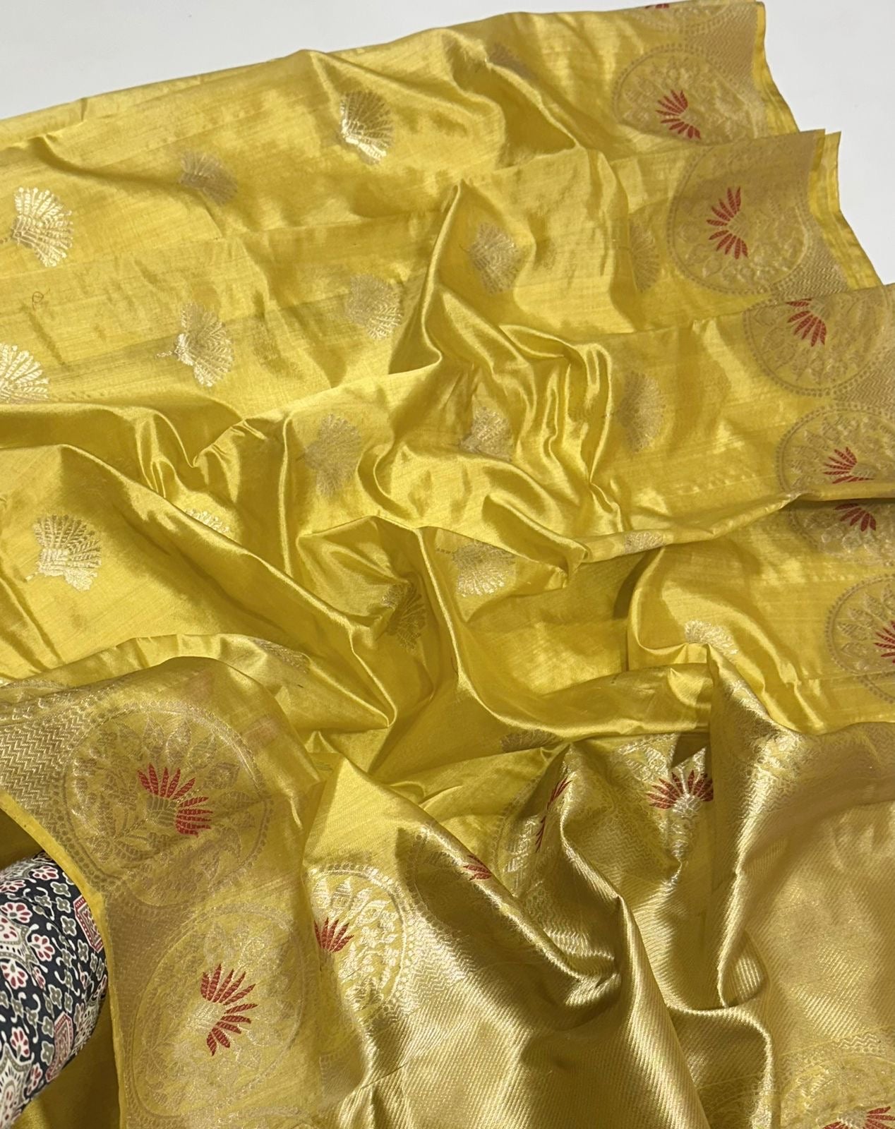 Zari border with circular medallion motifs in red on golden yellow Chanderi saree