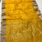 Turmeric yellow Chanderi saree opened to show the champagne-silver borders and luminous woven pallu
