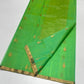Sea glass green Katan silk Chanderi saree laid open showing gold-toned butis, narrow gold border and shimmering pallu