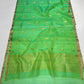 Sea glass green Chanderi saree opened to show small gold-toned butis and the broad shimmering woven pallu