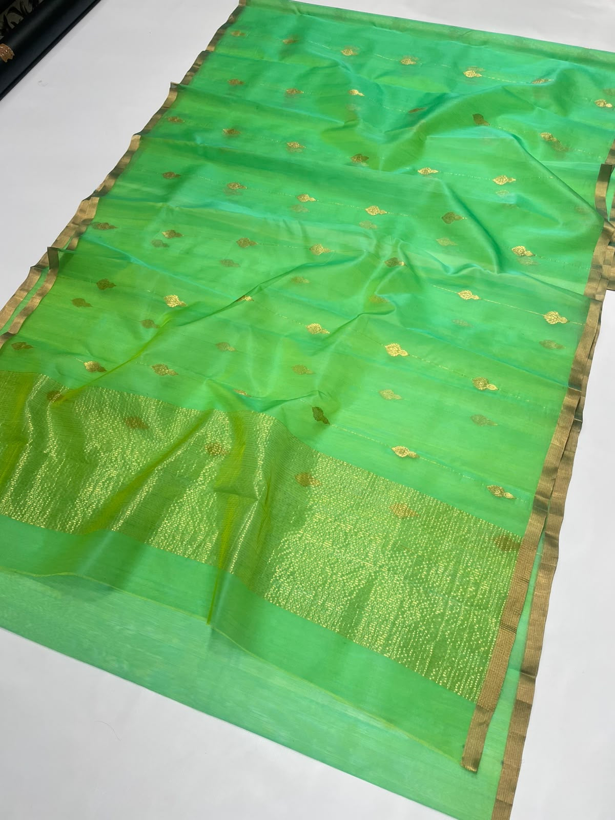Sea glass green Chanderi saree showing the fresh green shot silk body, gold-toned butis and textured pallu