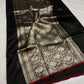 Black Chanderi silk saree displaying a richly patterned silver-champagne floral pallu and red selvedge