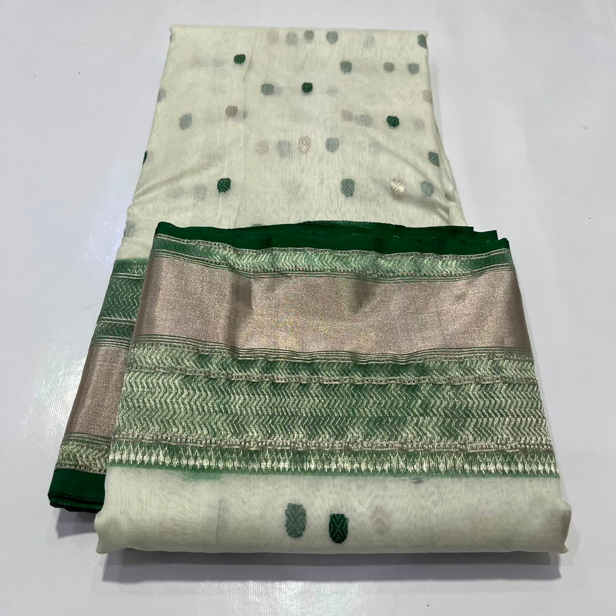 Warm ivory Katan Silk Chanderi saree with emerald-green and silver butis