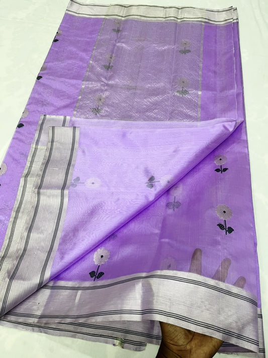 Lilac Pattu silk Chanderi saree laid open showing white floral butis, silver-toned striped border and pallu