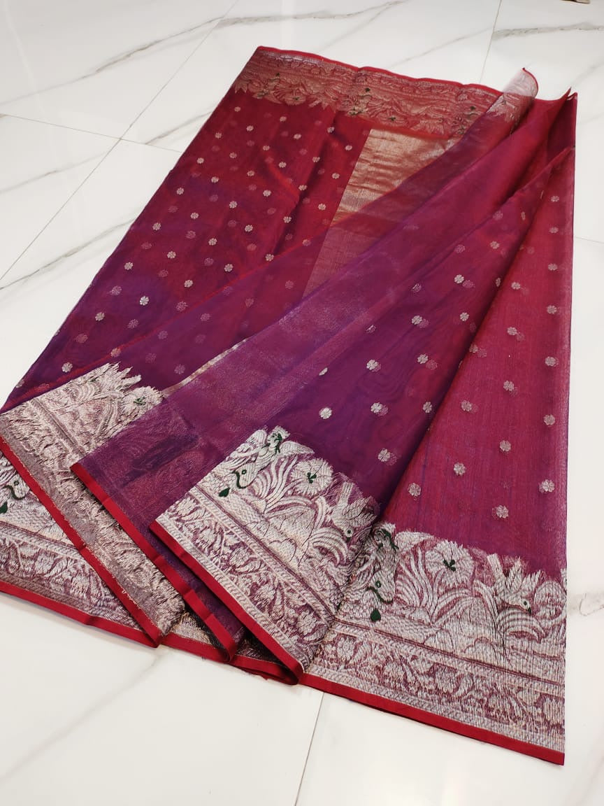 Front pleats of a berry red Chanderi Katan Silk saree showing tiny silver blossoms