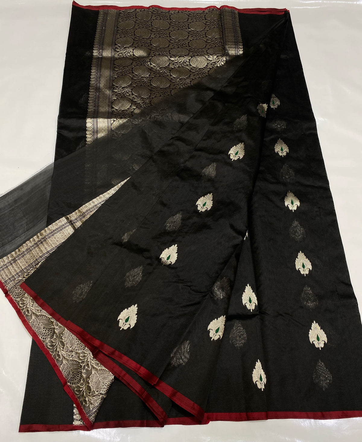 Midnight black Chanderi Pattu Silk saree with silver floral motifs, emerald accents and burgundy-red edges