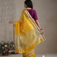 Marigold yellow Chanderi silk saree styled with gold jewellery, rust-red edge stripes visible