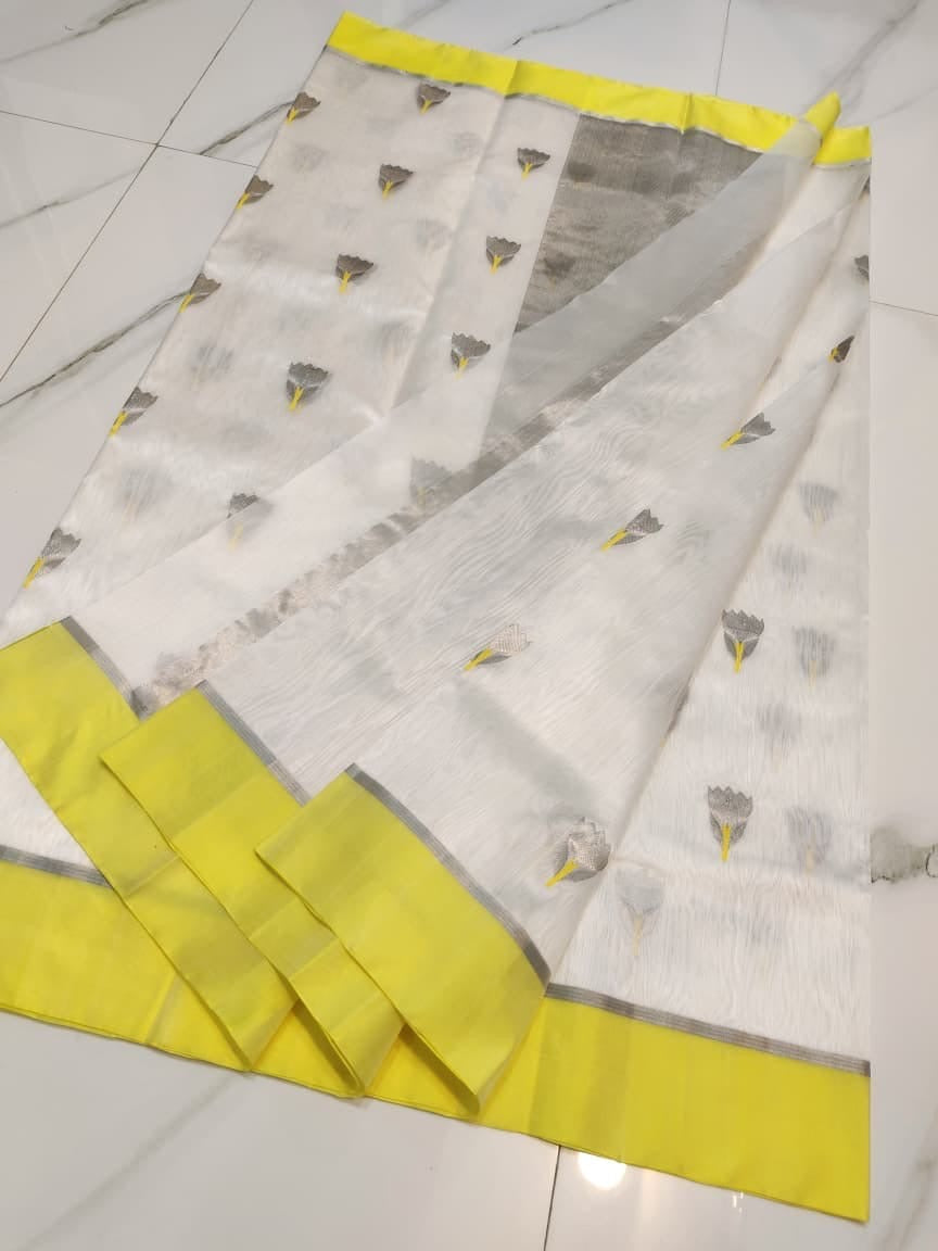 Ivory Chanderi Pattu silk saree folded to show the lemon-yellow border and grey floral buttas on the sheer body