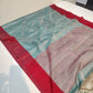 Back view of mist blue Chanderi Tissue Silk saree with the rose-silver pallu falling over the shoulder