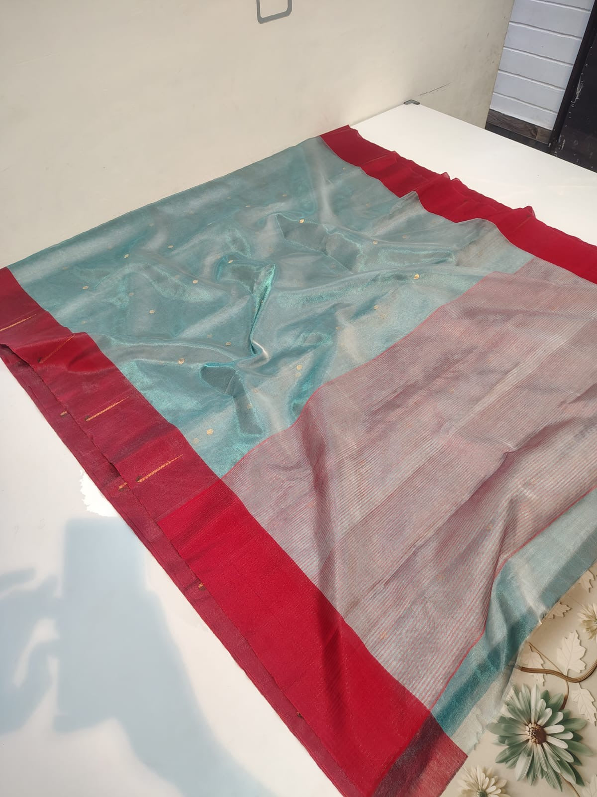 Back view of mist blue Chanderi Tissue Silk saree with the rose-silver pallu falling over the shoulder