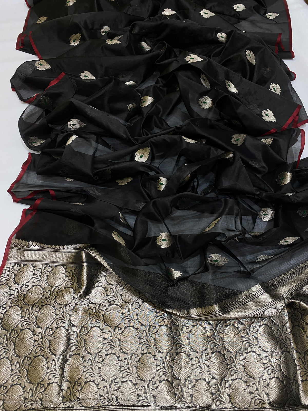 Close-up of a midnight black Chanderi Pattu Silk body with pale silver blossoms and emerald accents