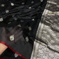 Border close-up of a black Chanderi silk saree with fine burgundy-red edging