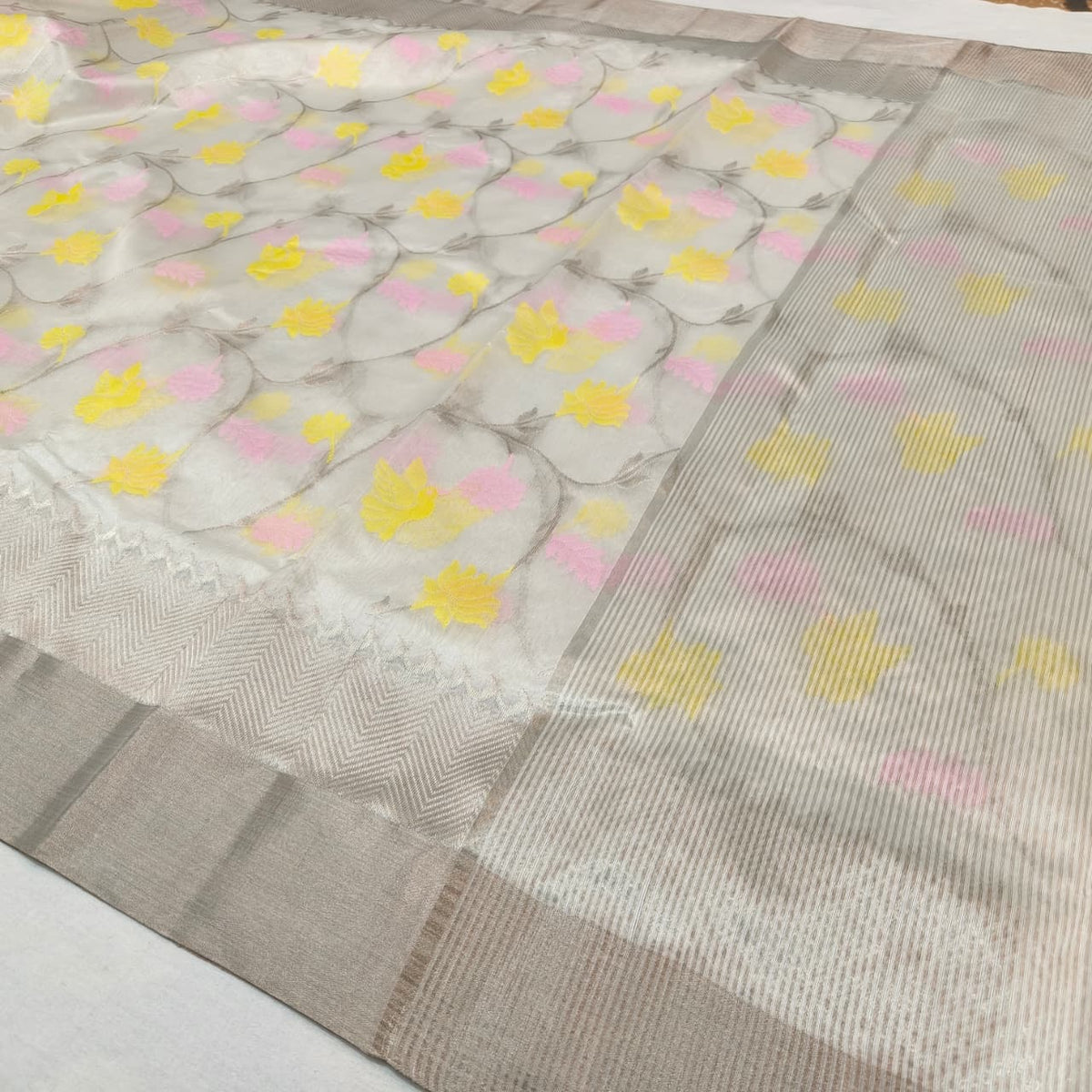 Warm ivory Chanderi saree with pink and yellow floral vines and silver-toned geometric border