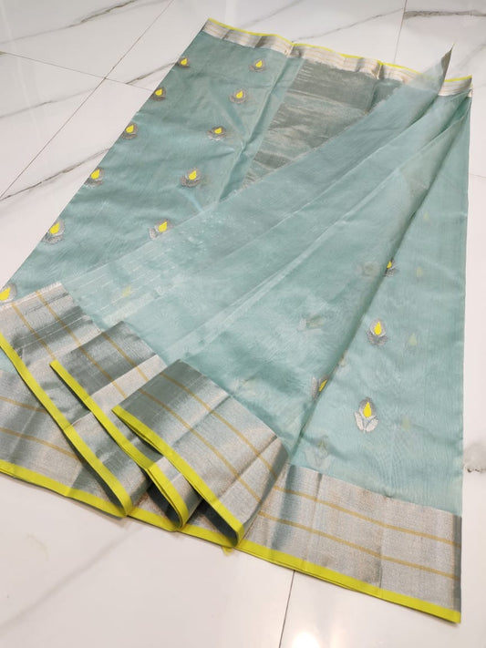 Mint blue Chanderi silk saree folded view with floral butti and antique gold zari border