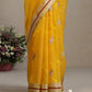 Folded marigold yellow Chanderi silk saree showing ivory bird motif and contrasting silver-gold border