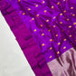 Close-up of vibrant purple Chanderi handloom silk with scattered saffron flowers, plum border and textured pallu.