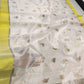 Ivory Chanderi saree showing scattered grey floral buttas alongside the lemon-yellow border and silver pallu