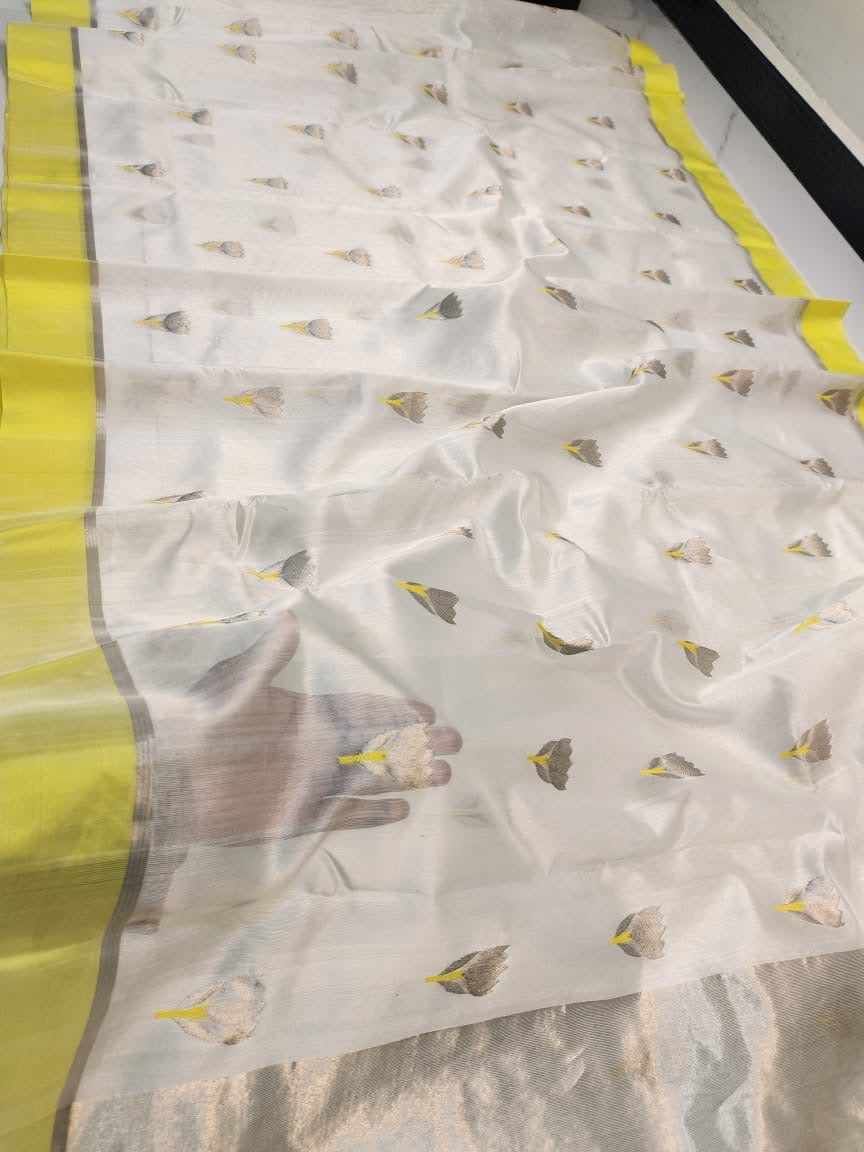 Ivory Chanderi saree showing scattered grey floral buttas alongside the lemon-yellow border and silver pallu