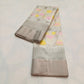 Close view of warm ivory Chanderi silk with pastel floral motifs