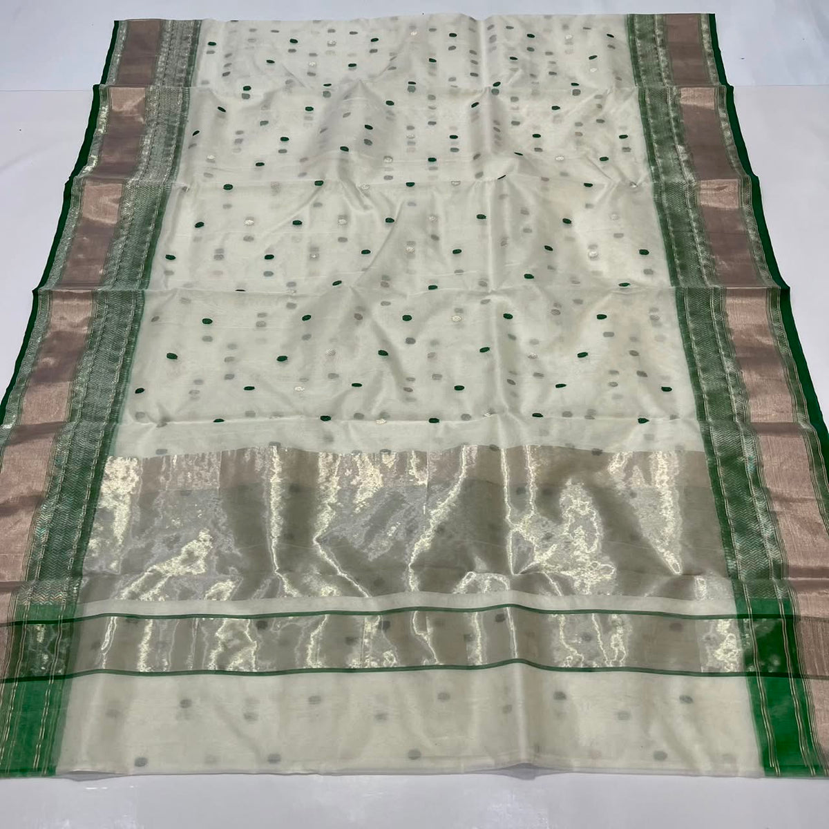 Warm ivory and emerald green Chanderi saree with silver border