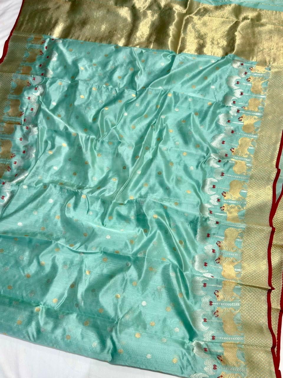 Seafoam blue Chanderi pattu silk saree with sona-roopa butis, ornamental gold border and shimmering pallu