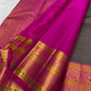 Folded Charcoal Grey Korvai saree highlighting statement gold zari butta and intricate Rani Pink border.