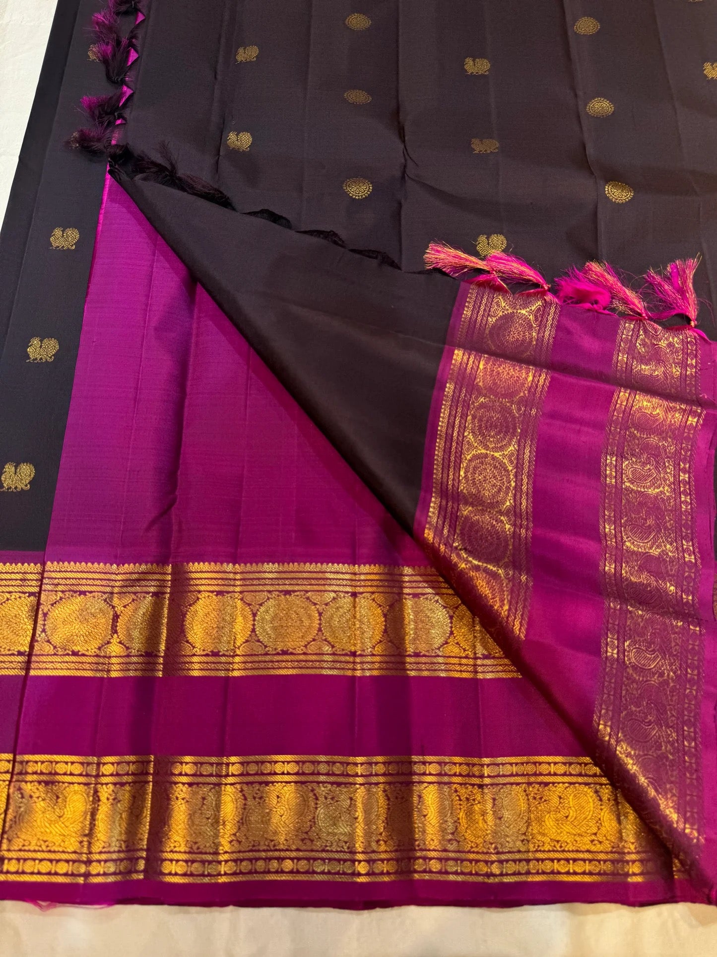 Folded view of dark charcoal and magenta Kanchipuram silk saree with zari kattam body — Idam Living