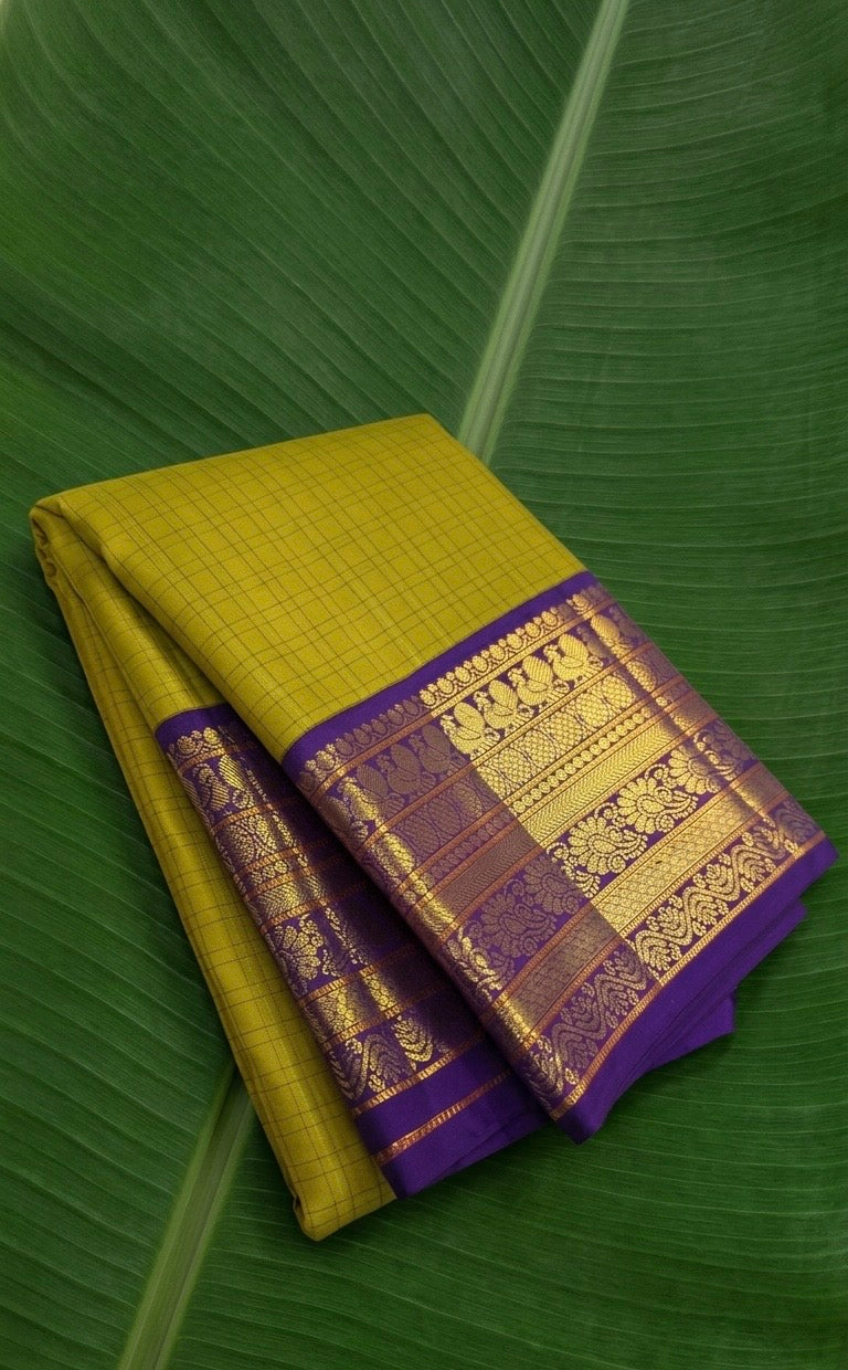Pure Kanchipuram silk saree in chartreuse green with royal indigo border and Annapakshi zari motifs