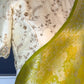 Close view of zari buttas on yellow green Pure Katan Silk Banarasi saree
