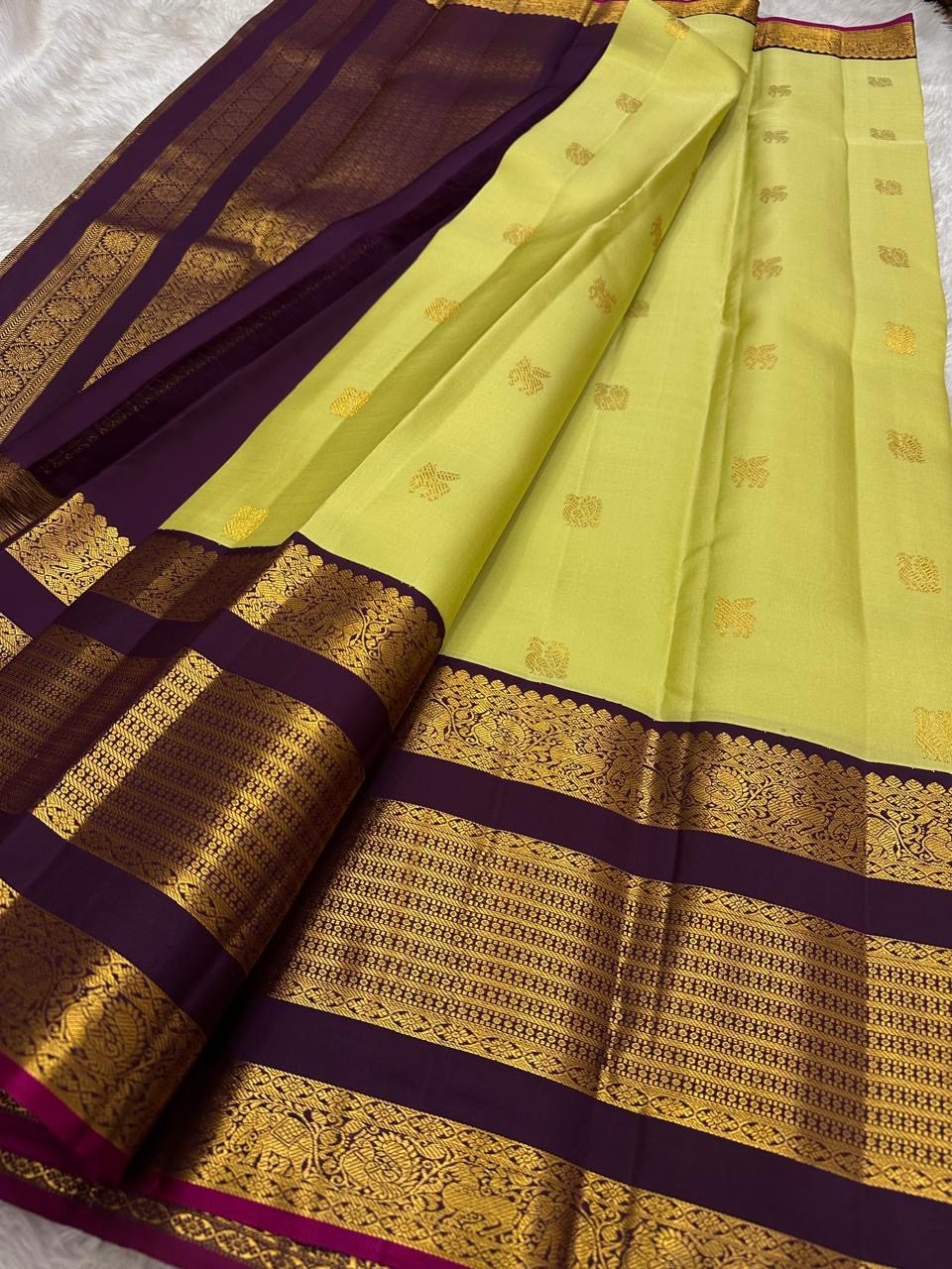 Deep purple pallu of lime chartreuse Kanjipuram pure silk saree with cascading Kai Korvai dense antique gold zari