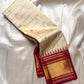 Ivory kattam Pure Kanchipuram silk saree drape showing zari buttas and a tomato red border with gold zari woven detailing.
