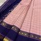 Full spread blush pink checked pure Kanchipuram silk saree with deep navy border, tassels, and gold zari detailing along the edg