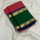 Folded pure Kanchipuram silk saree with red checks, green panel, navy border, and gold zari bands on white fabric backdrop.
