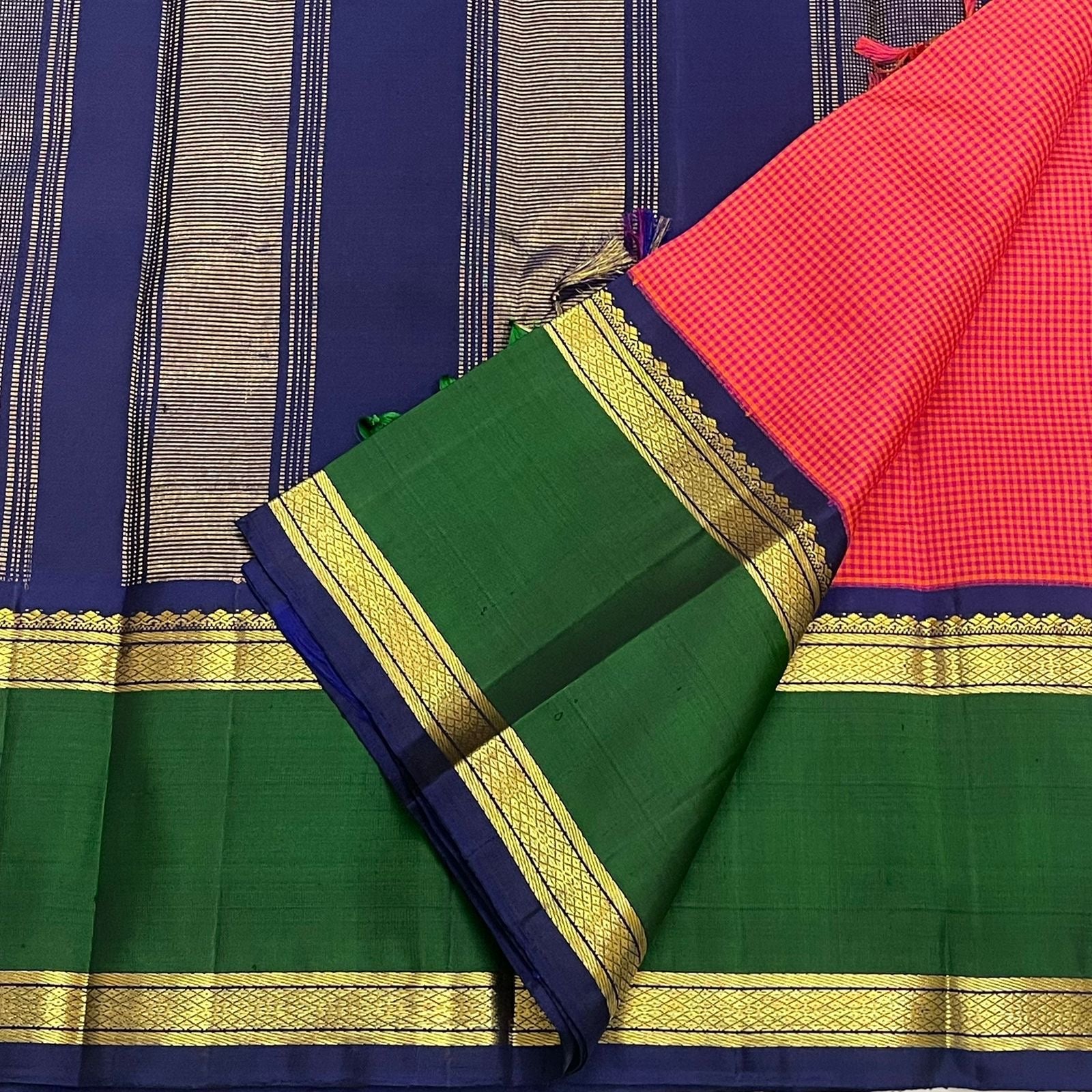 Pure Kanchipuram silk saree pallu detail in navy with vertical zari stripes, paired with green border and gold zari bands.