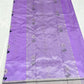 Lilac Chanderi saree opened to show the silver-toned striped borders and luminous floral pallu