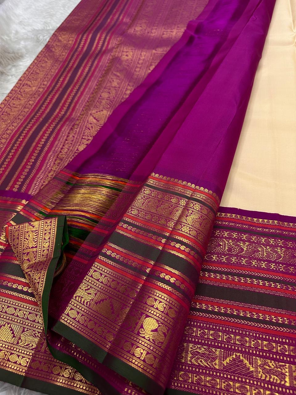 Classic Ivory Kanjipuram Saree — raspberry magenta and deep green Korvai border with peacock motifs