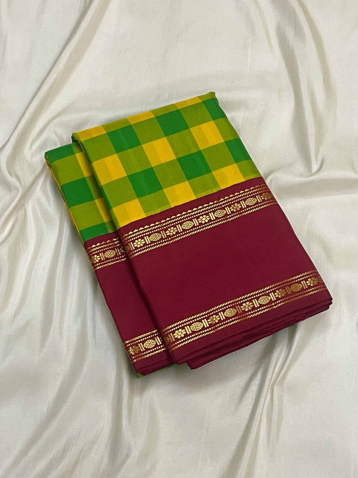 Classic Kanchipuram kattam saree in manjal yellow and ilai pachai with a deep kungumam red Rettapet border and Rudraksham detail.
