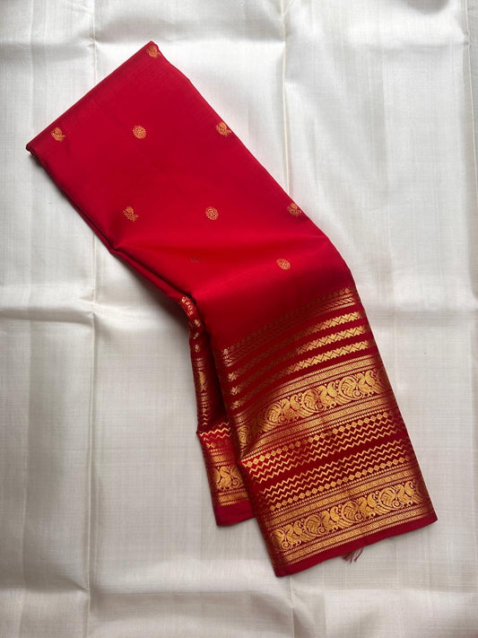 Pure Kanchipuram silk saree in kumkum red with traditional gold zari varisaipet border