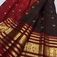 Arakku red Varisaipet border with layered gold zari registers and peacock imagery on a deep plum silk saree