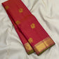 Long folded rani pink vairaoosi Kanchipuram silk saree showing gold zari buttas and wide zari border with green selvedge