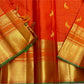 closeup of gold zari pallu detailing on vermillion orange kanchipuram silk saree shipped from New Jersey USA